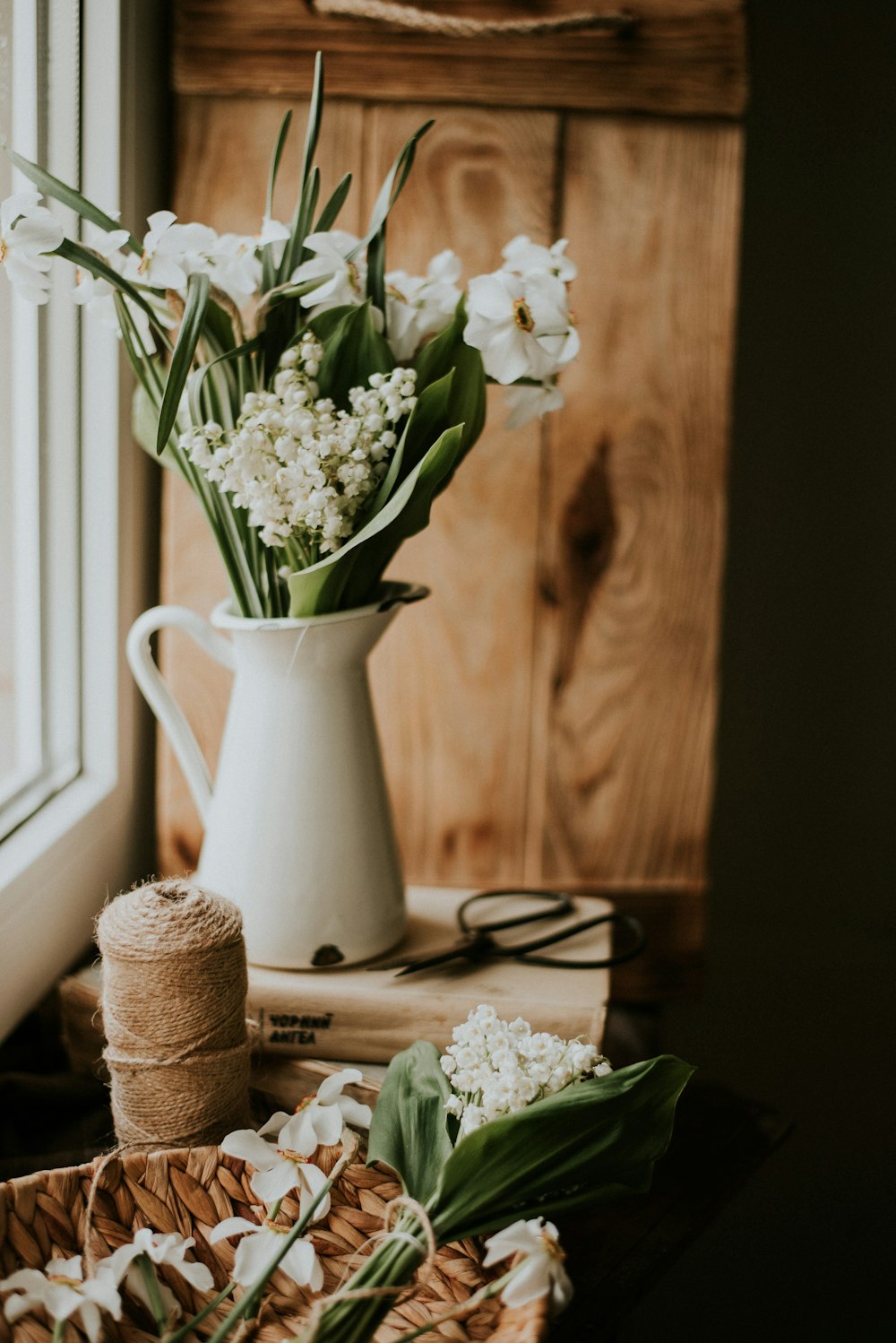 white flowers in white ceramic vase