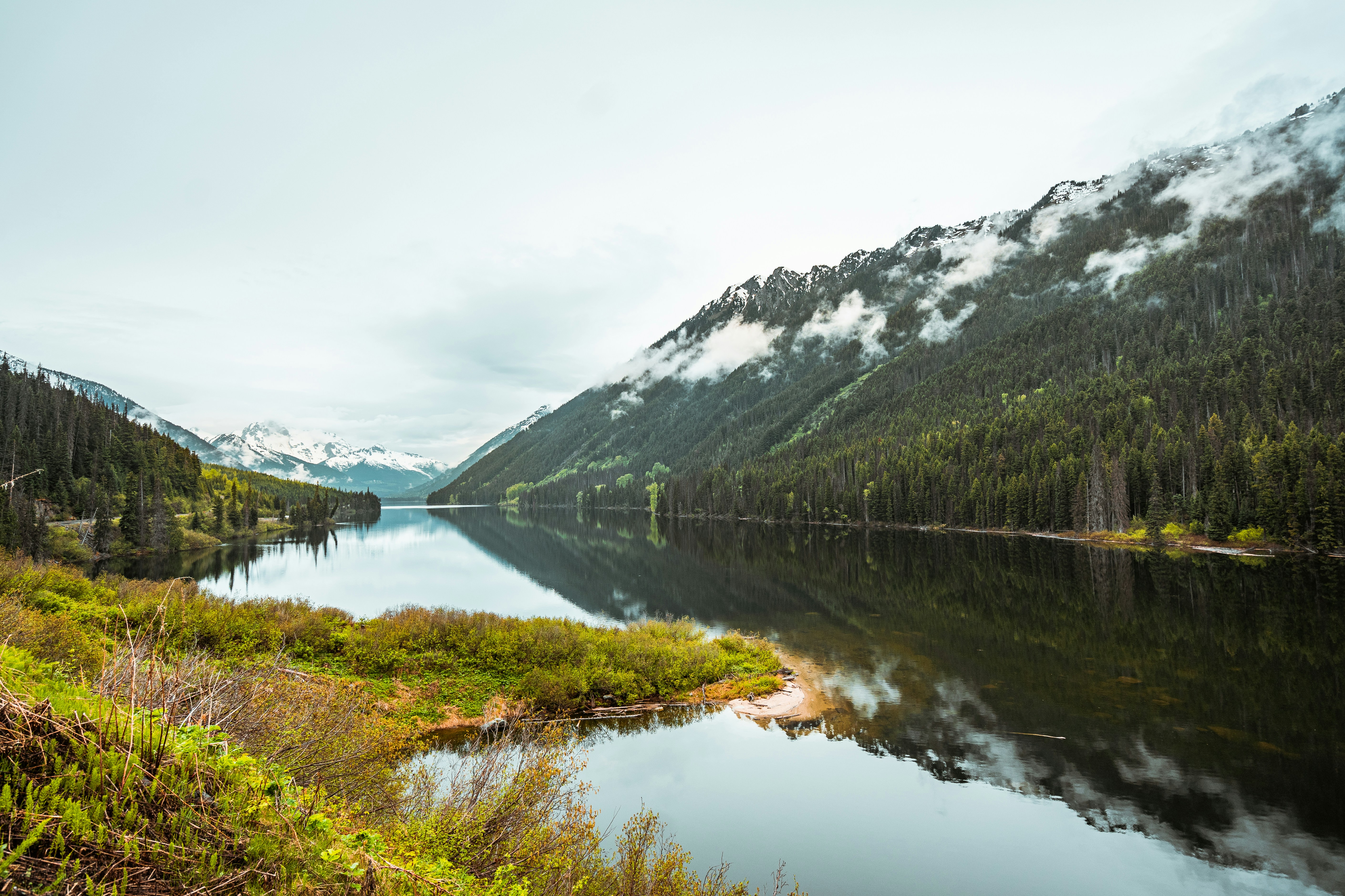 Hero image for Sea-to-Sky Luxury Loop: Vancouver & Beyond (3 Days) - green and white mountain beside lake under white sky during daytime -  in Western Canada - Photo by Aditya Chinchure on Unsplash