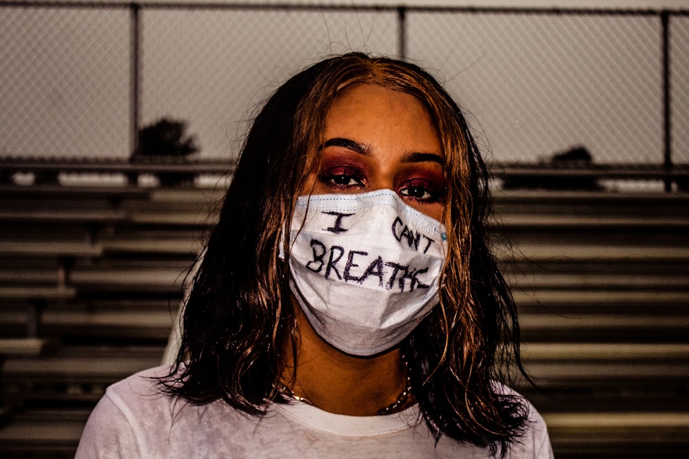 woman in white crew neck shirt with white and black face mask