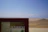 Smiling traveler enjoying a scenic desert tour in Ica with a guide.