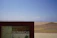 Smiling traveler enjoying a scenic desert tour in Ica with a guide.