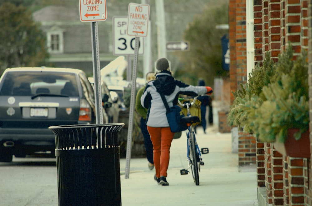 man in black jacket riding bicycle during daytime