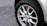 Close-up of a shiny new brake rotor installed on a car wheel.