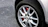 Close-up of a shiny new brake rotor installed on a car wheel.