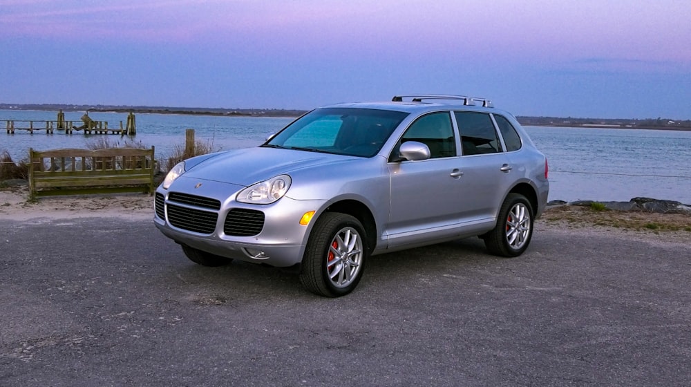 silver mercedes benz c class parked on gray sand during daytime