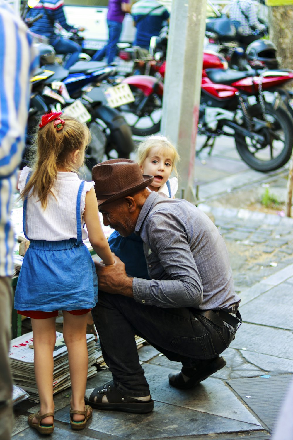 man and woman kissing on street during daytime