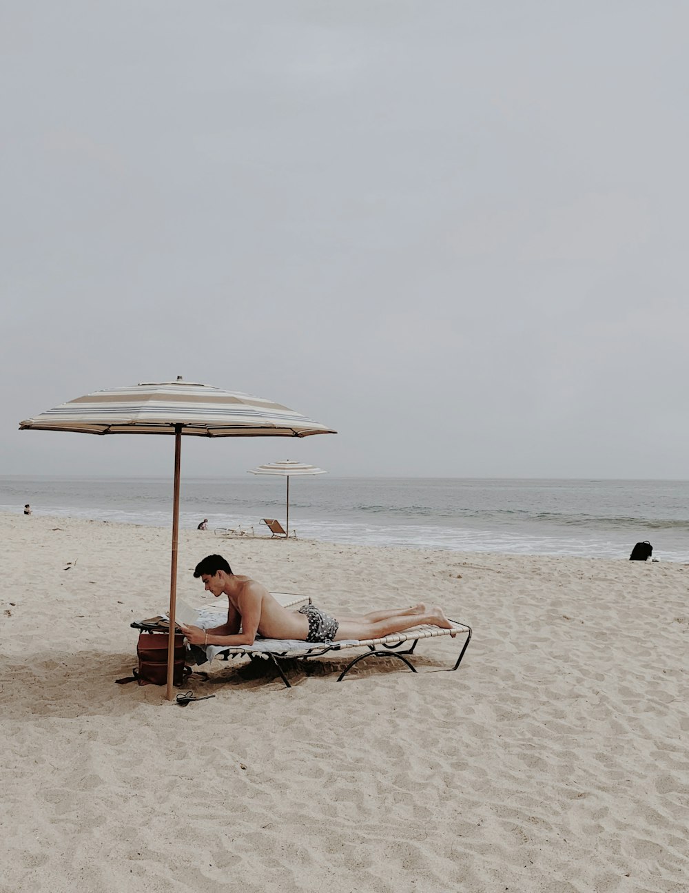 woman in white bikini lying on beach lounge chair on beach during daytime