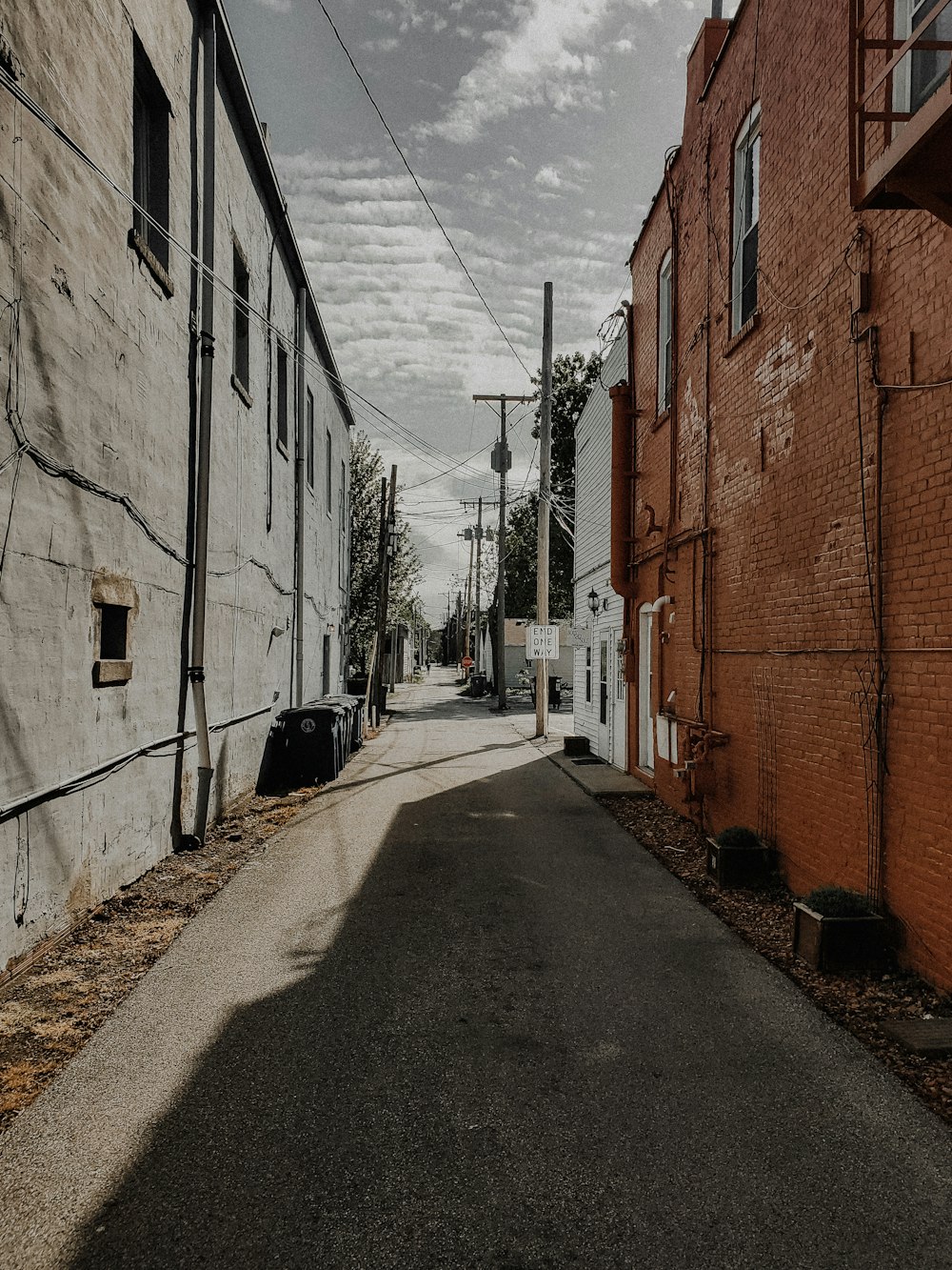 brown brick building beside road during daytime