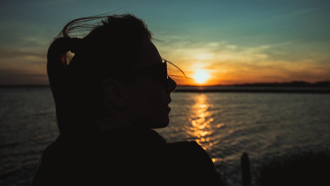 silhouette of man wearing sunglasses during sunset