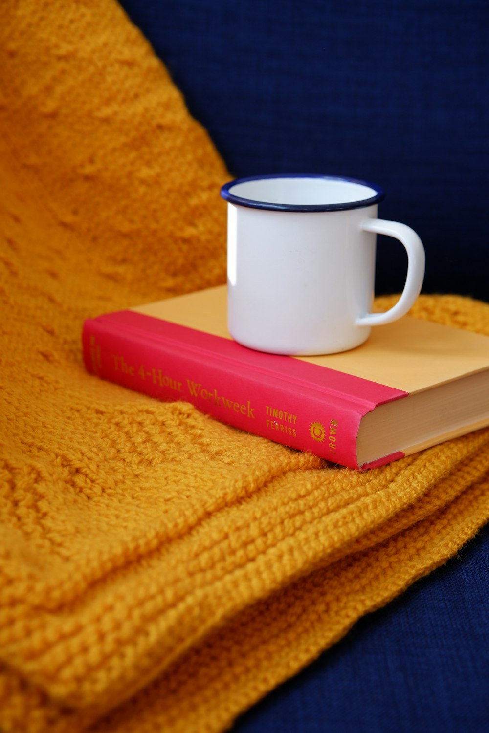 white ceramic mug on yellow textile