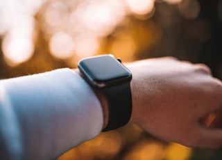 person wearing silver aluminum case apple watch with white sport band