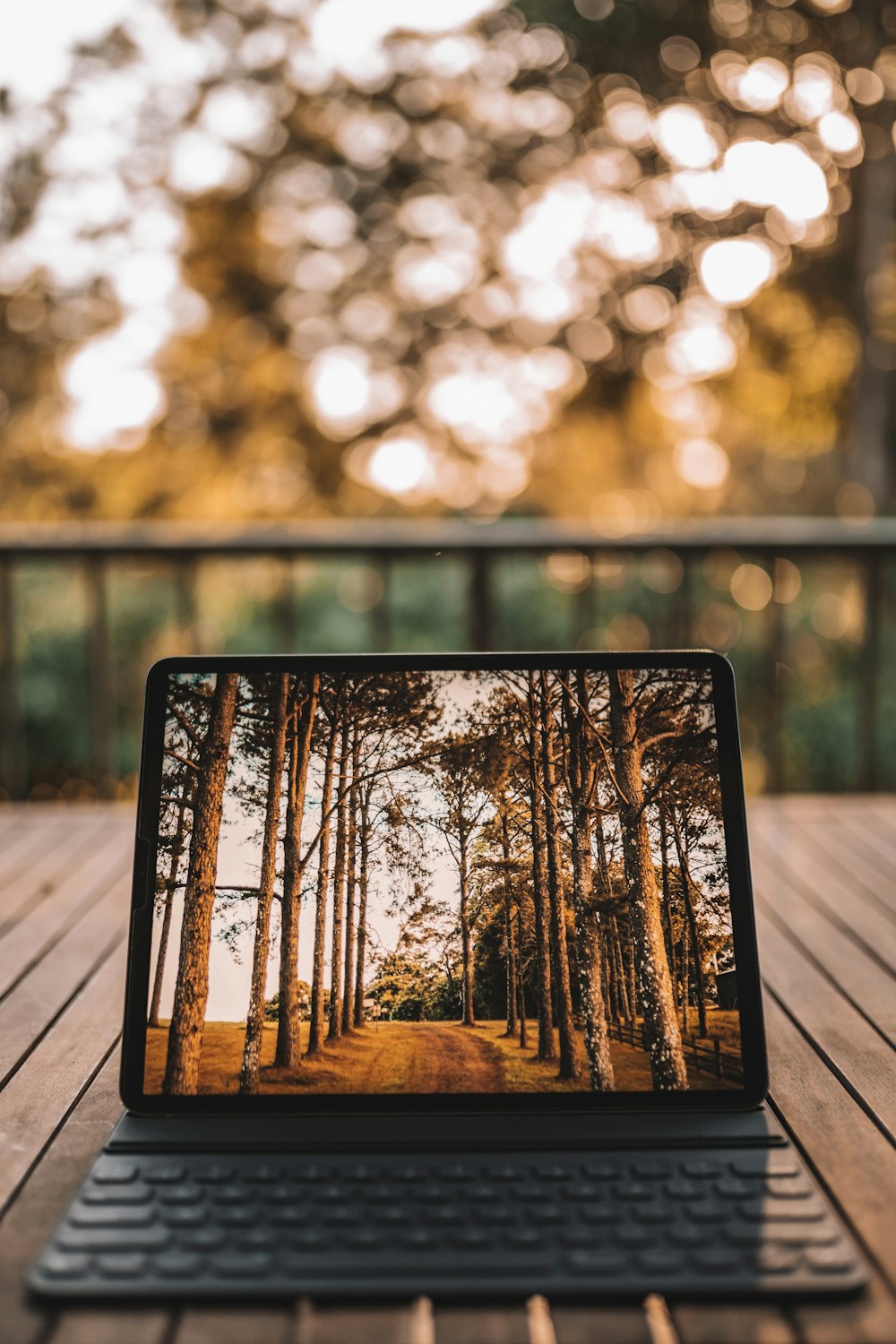 black ipad on brown wooden table