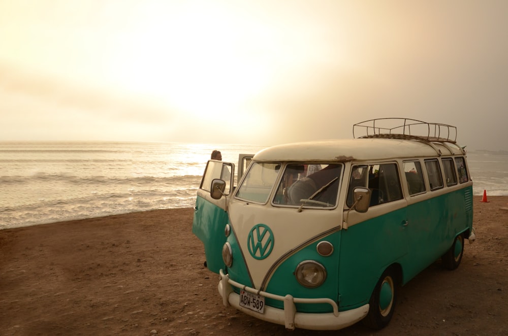 white and blue volkswagen t-1 on beach shore during daytime