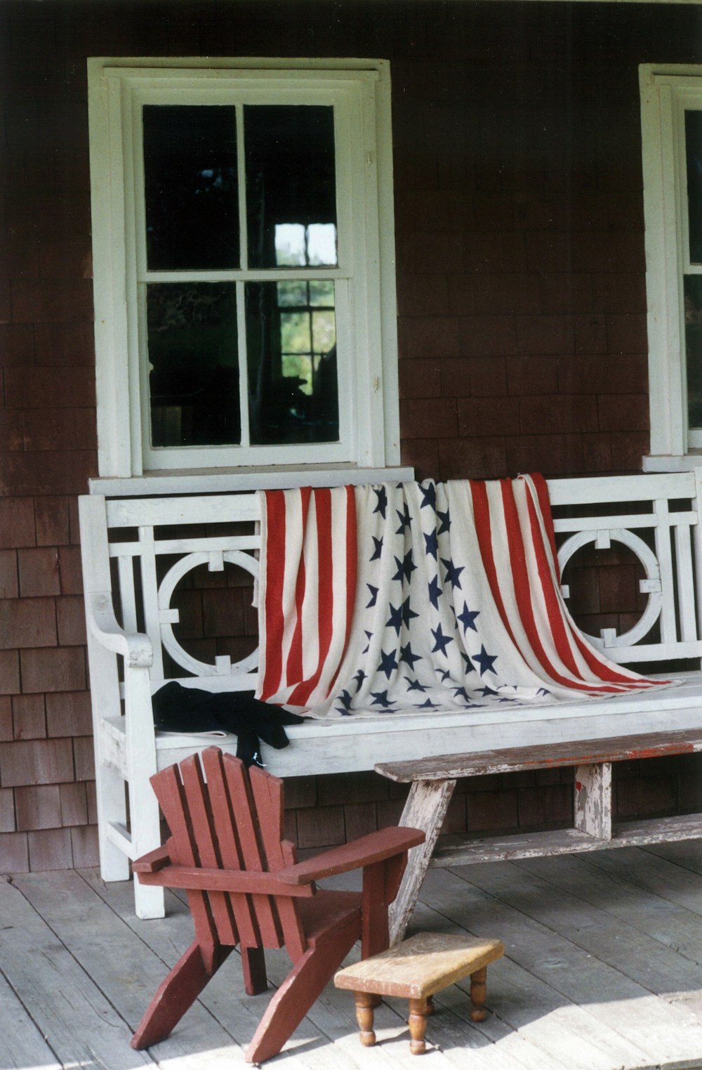 red and white striped folding chairs on brown wooden porch