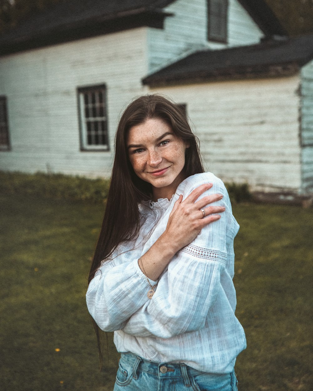 woman in white long sleeve shirt smiling