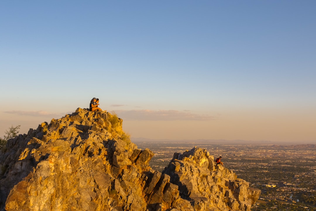 person standing on rock formation during daytime