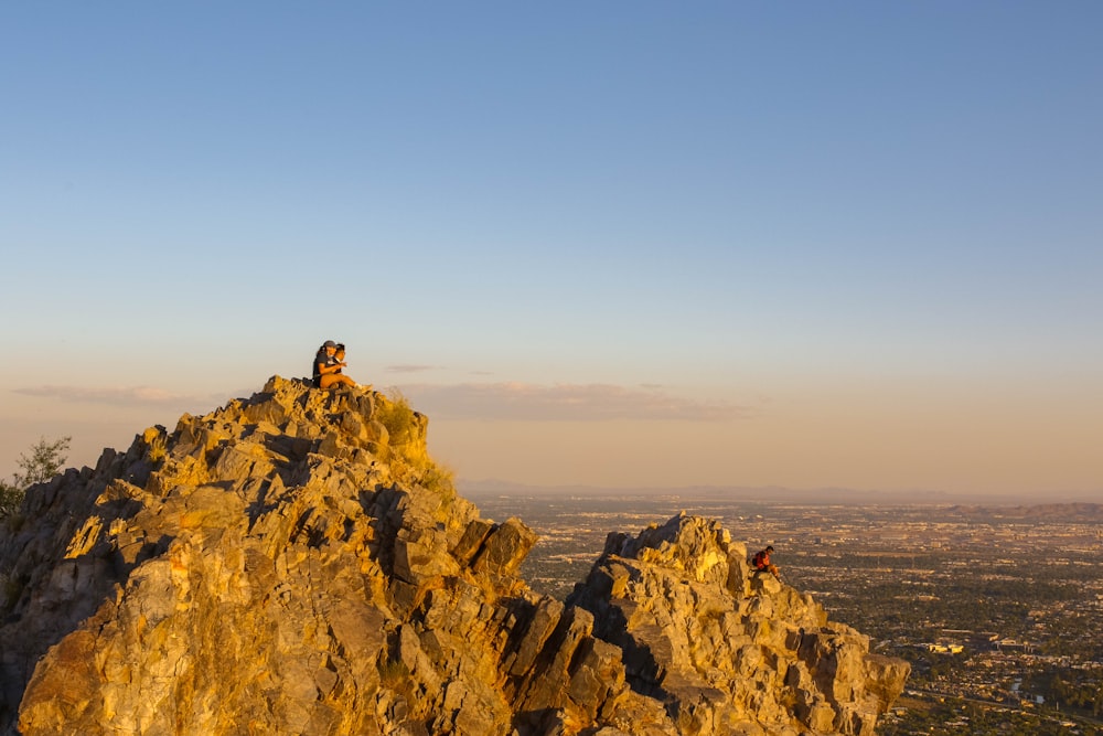 person standing on rock formation during daytime