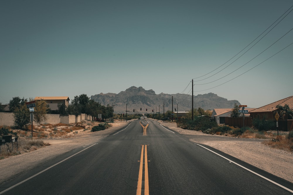 gray asphalt road under blue sky during daytime