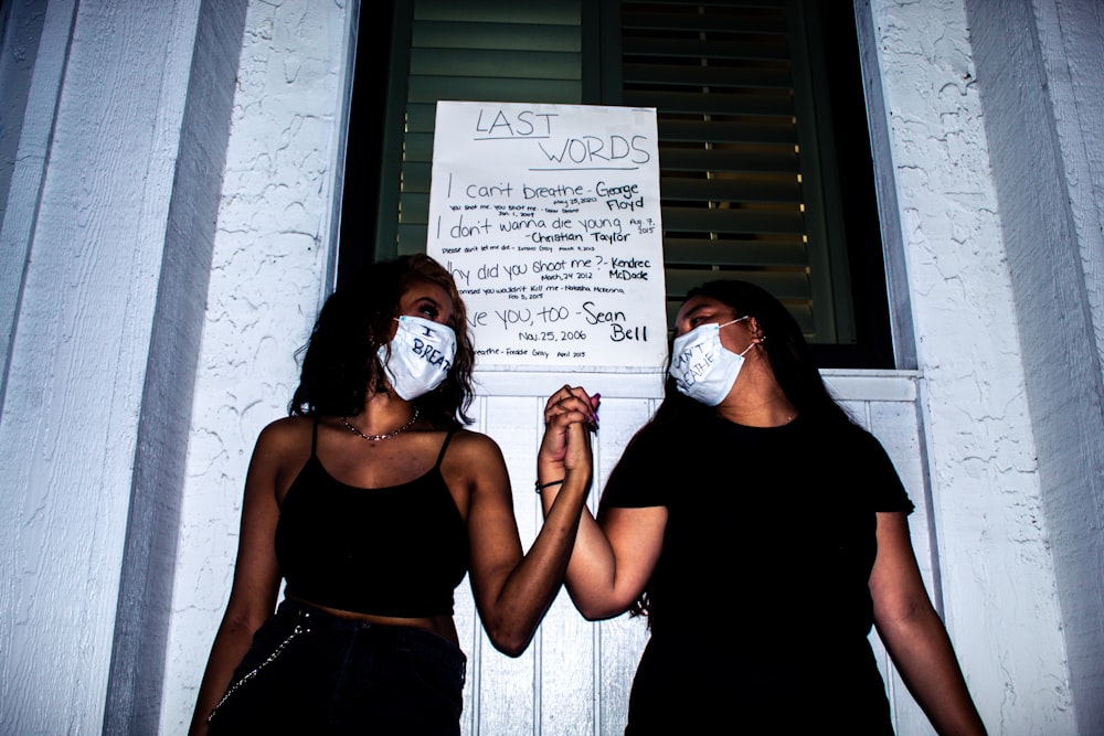 woman in black tank top wearing white mask