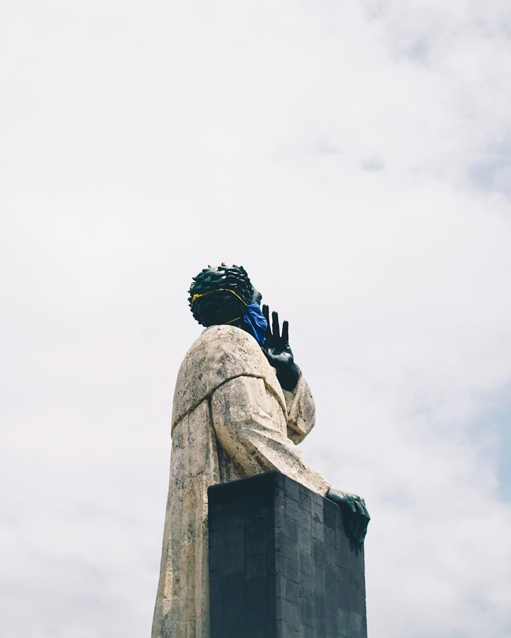 man in black helmet and black helmet on top of gray concrete statue