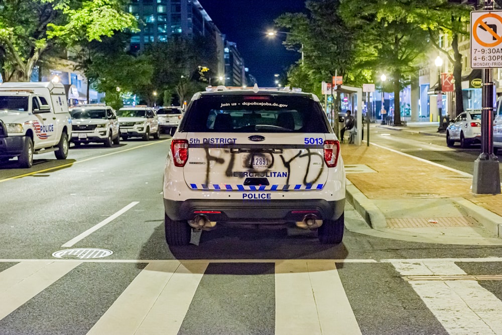 white and black ford mustang on road during night time