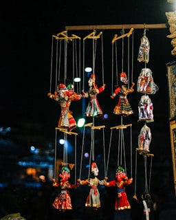 A whimsical puppet stage adorned with colorful puppets and dramatic lighting, inviting an audience to explore the art of puppetry.