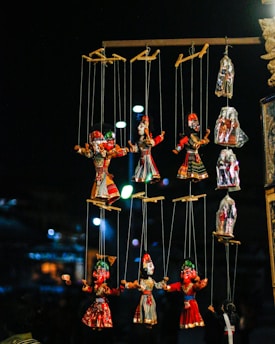 A whimsical puppet stage adorned with colorful puppets and dramatic lighting, inviting an audience to explore the art of puppetry.