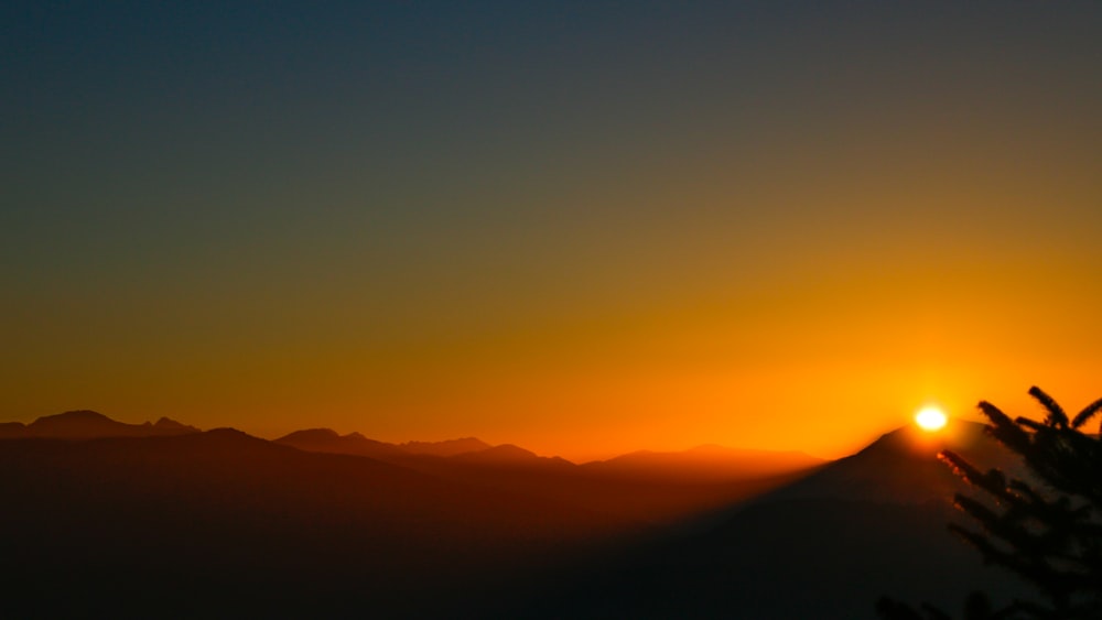 silhouette of mountains during sunset