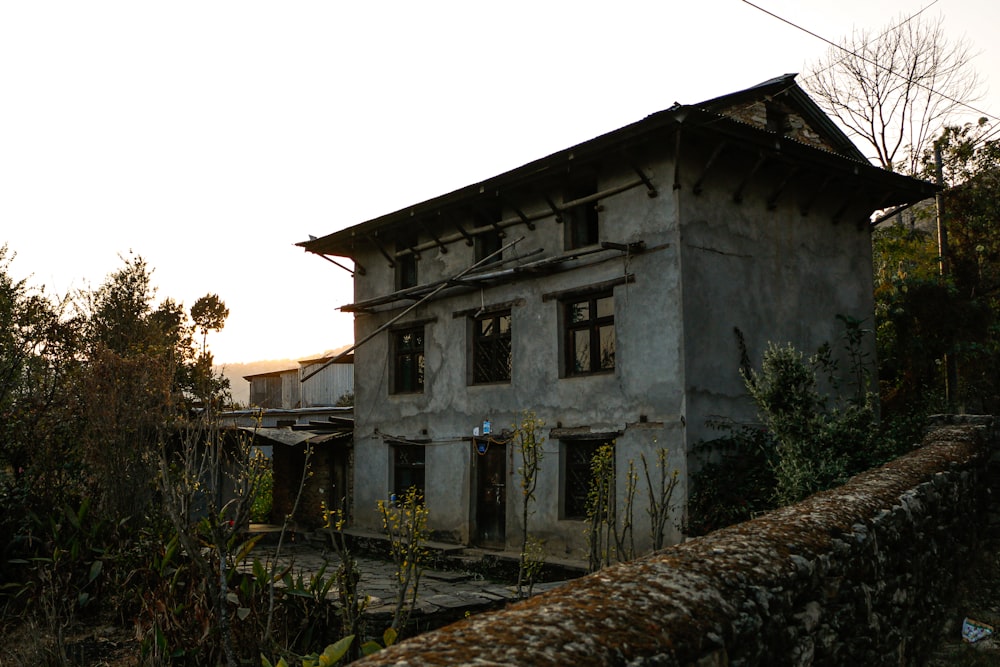 gray concrete building near green trees during daytime