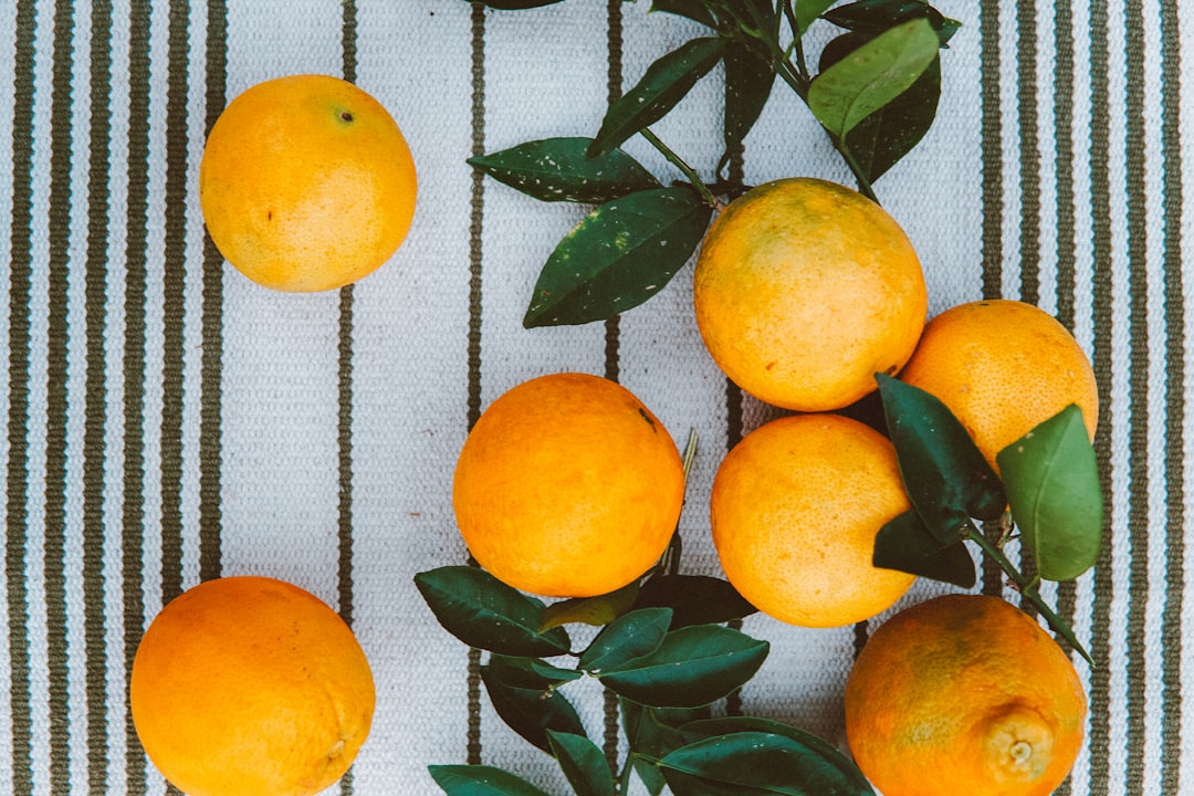 orange fruit on white and blue textile