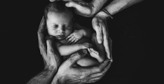 grayscale photo of woman hugging baby