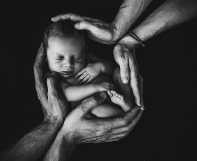 grayscale photo of woman hugging baby