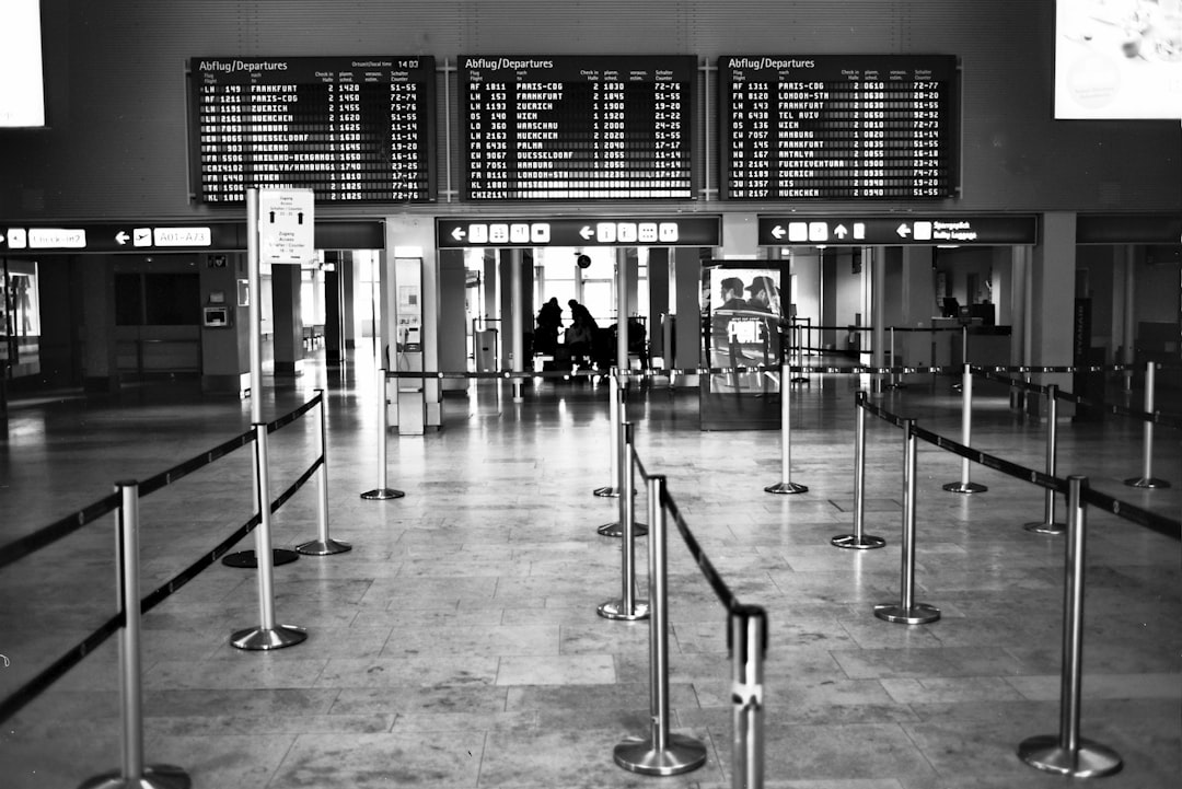 people walking inside building with glass walls, Empty airport at stayhome corona virus. Made with Leica R7 (Year: 1994)