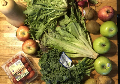 A vibrant assortment of exotic tropical vegetables arranged on a rustic wooden table.