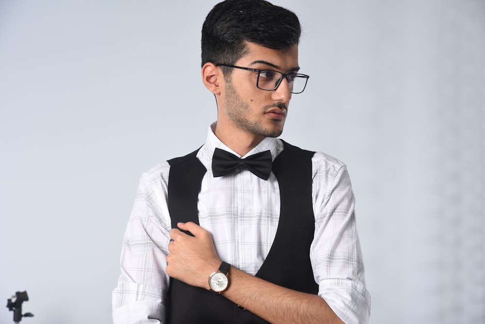 man in white and black button up shirt wearing black framed eyeglasses