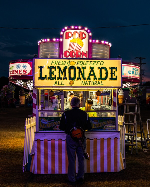 Guy with instrument getting lemonade.by Rojan Maharjan