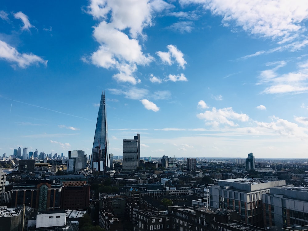 city skyline under blue and white sunny cloudy sky during daytime