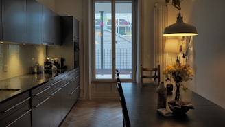 A bright kitchen with modern appliances and a dining table.