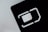 An abstract close-up of a SIM card slot icon, featuring bold, geometric lines and shapes. The negative space is emphasized with a contrasting light gray background and dark, shadowed interior.
