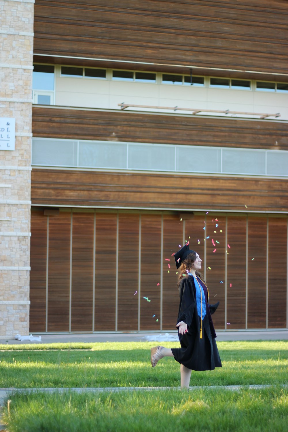 woman in black long sleeve dress standing on green grass field during daytime