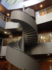 white spiral staircase with stainless steel railings