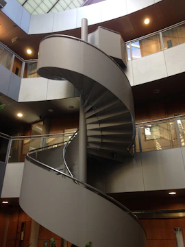 white spiral staircase with stainless steel railings