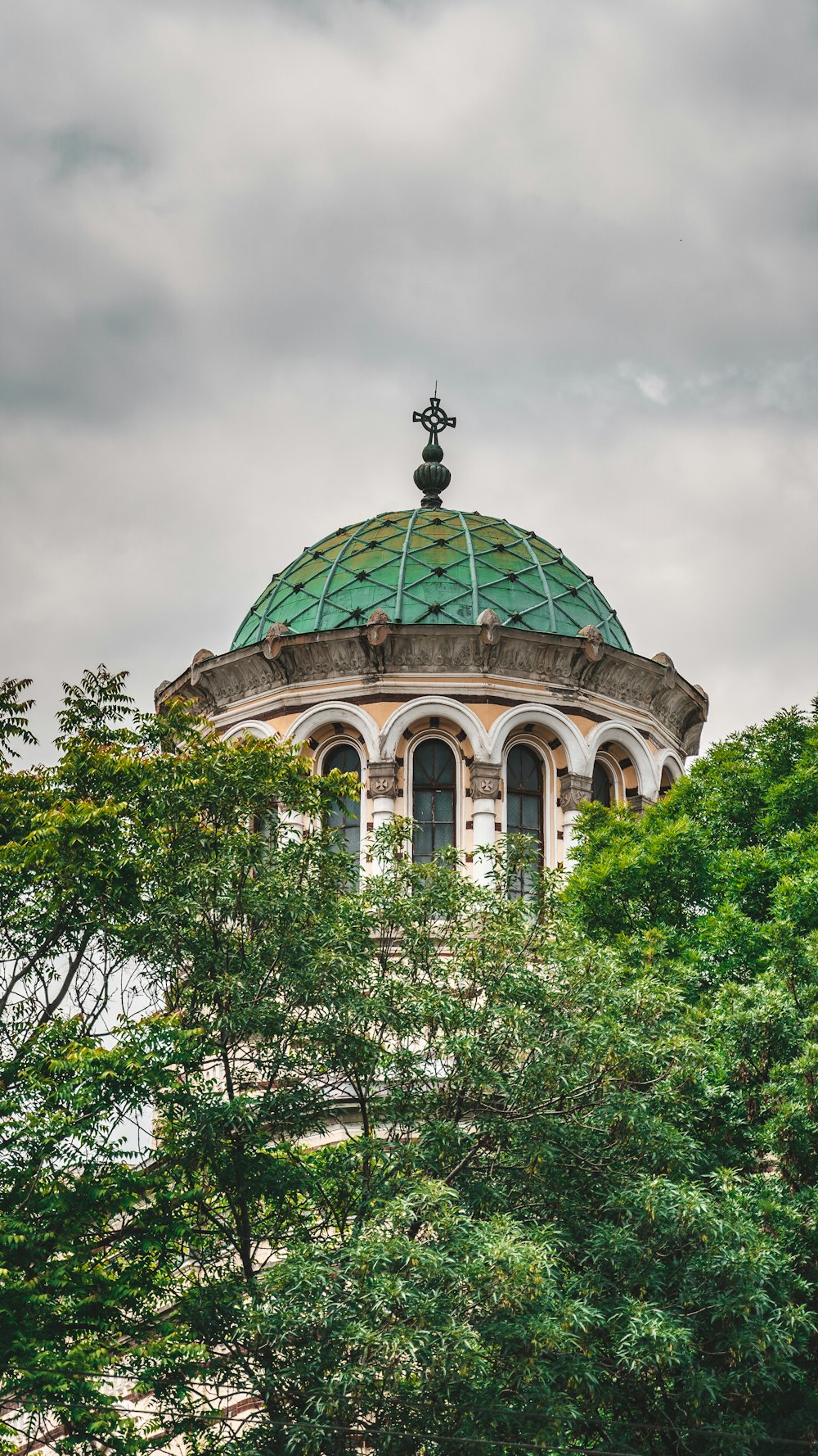 edifício da cúpula verde e branca sob nuvens brancas durante o dia