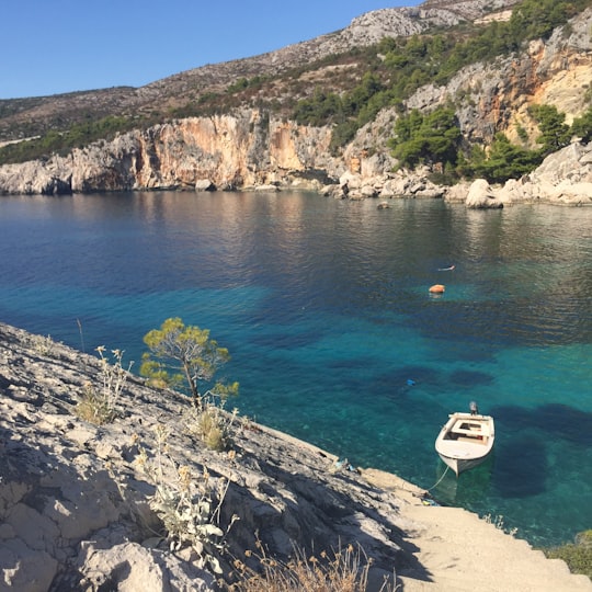 white yacht on blue sea during daytime in Hvar Croatia