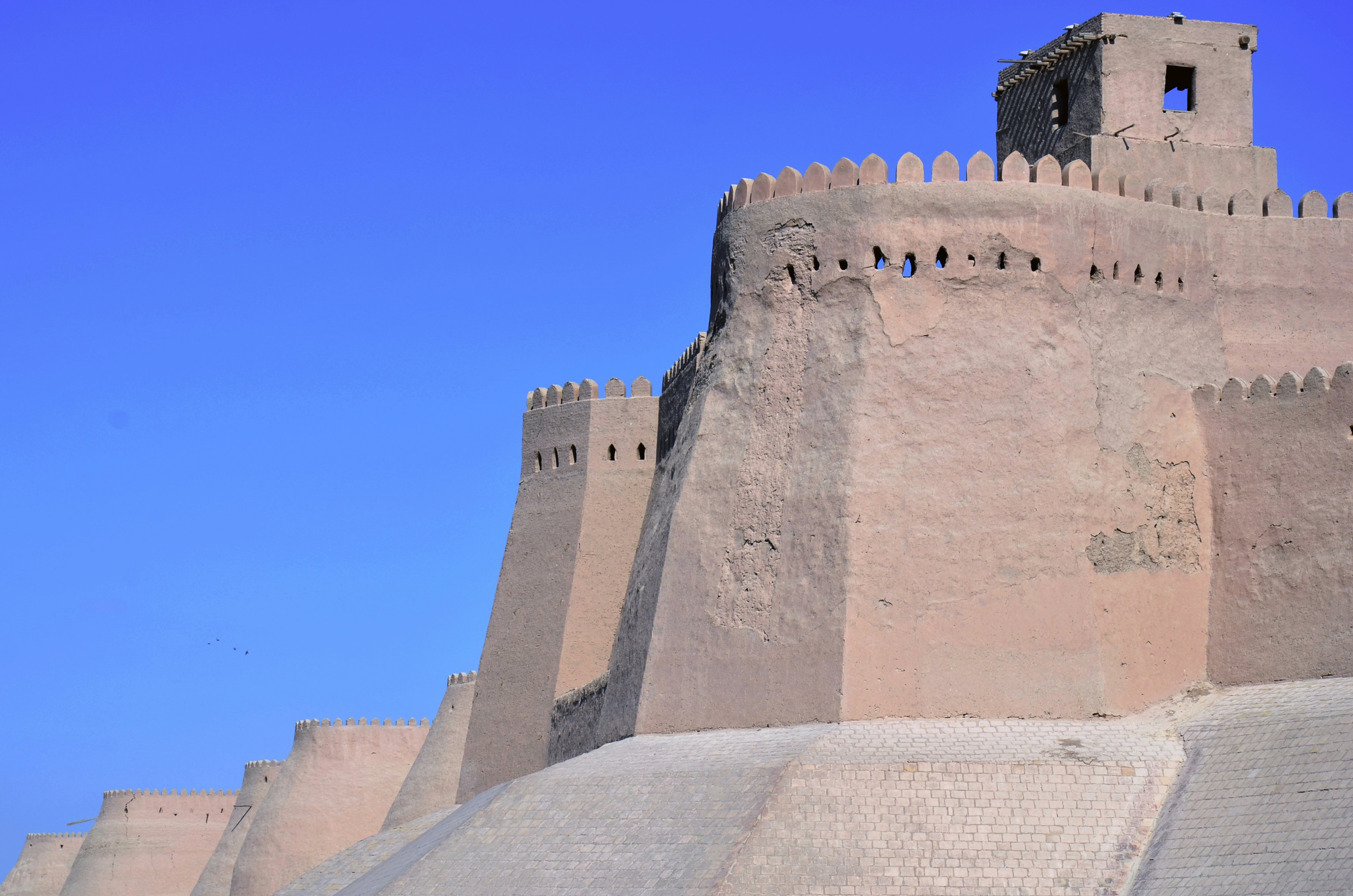 brown concrete castle under blue sky during daytime uzbekistan zoom background