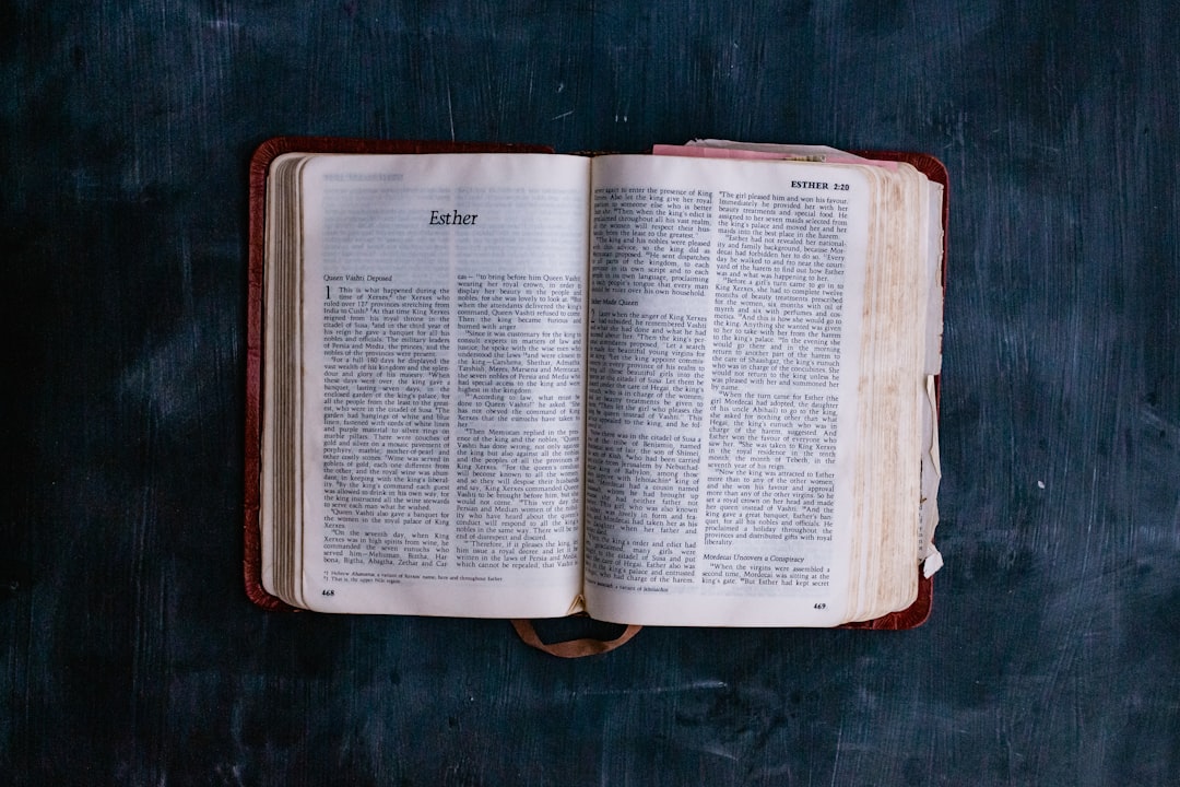 opened book on brown wooden table