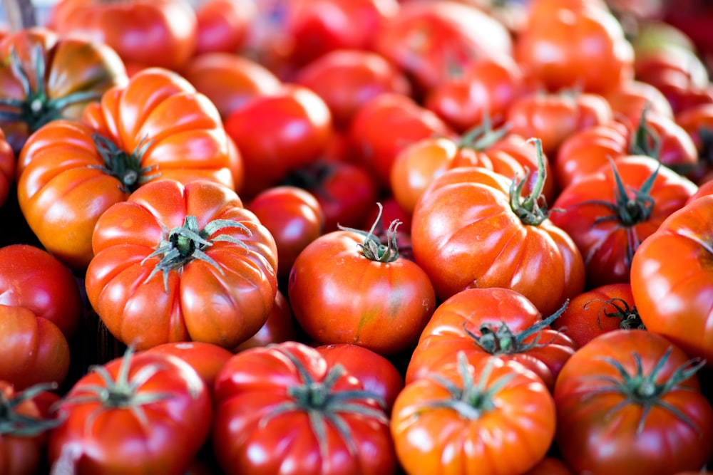 red tomato on brown wooden table