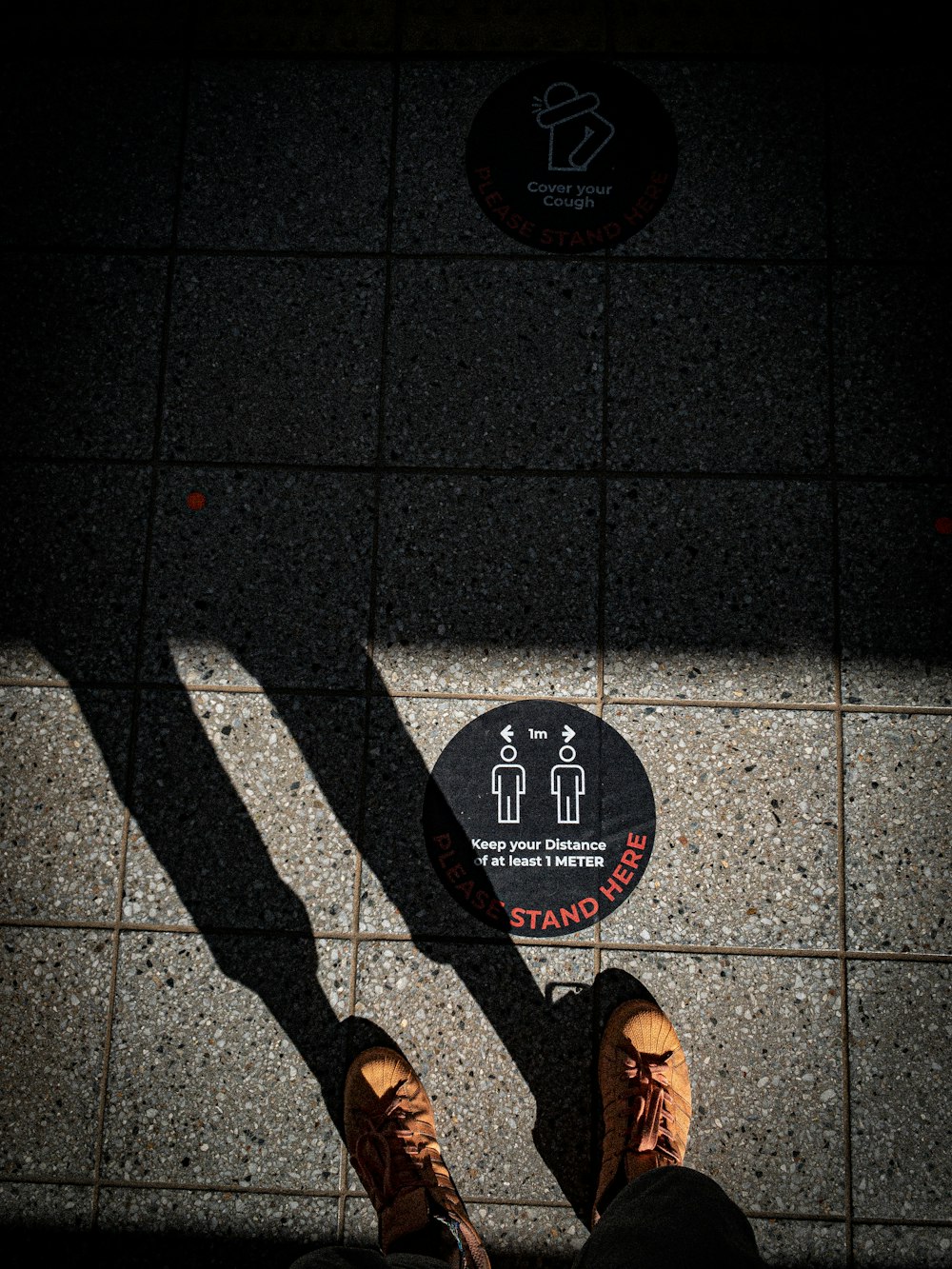 person standing on black and white floor tiles