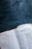 An open book lies on a dark wooden surface. The page visible is from the New Testament, specifically the Gospel of Matthew describing the genealogy of Jesus. The text is printed in a serif font. The pages beside it appear slightly worn, indicating use.