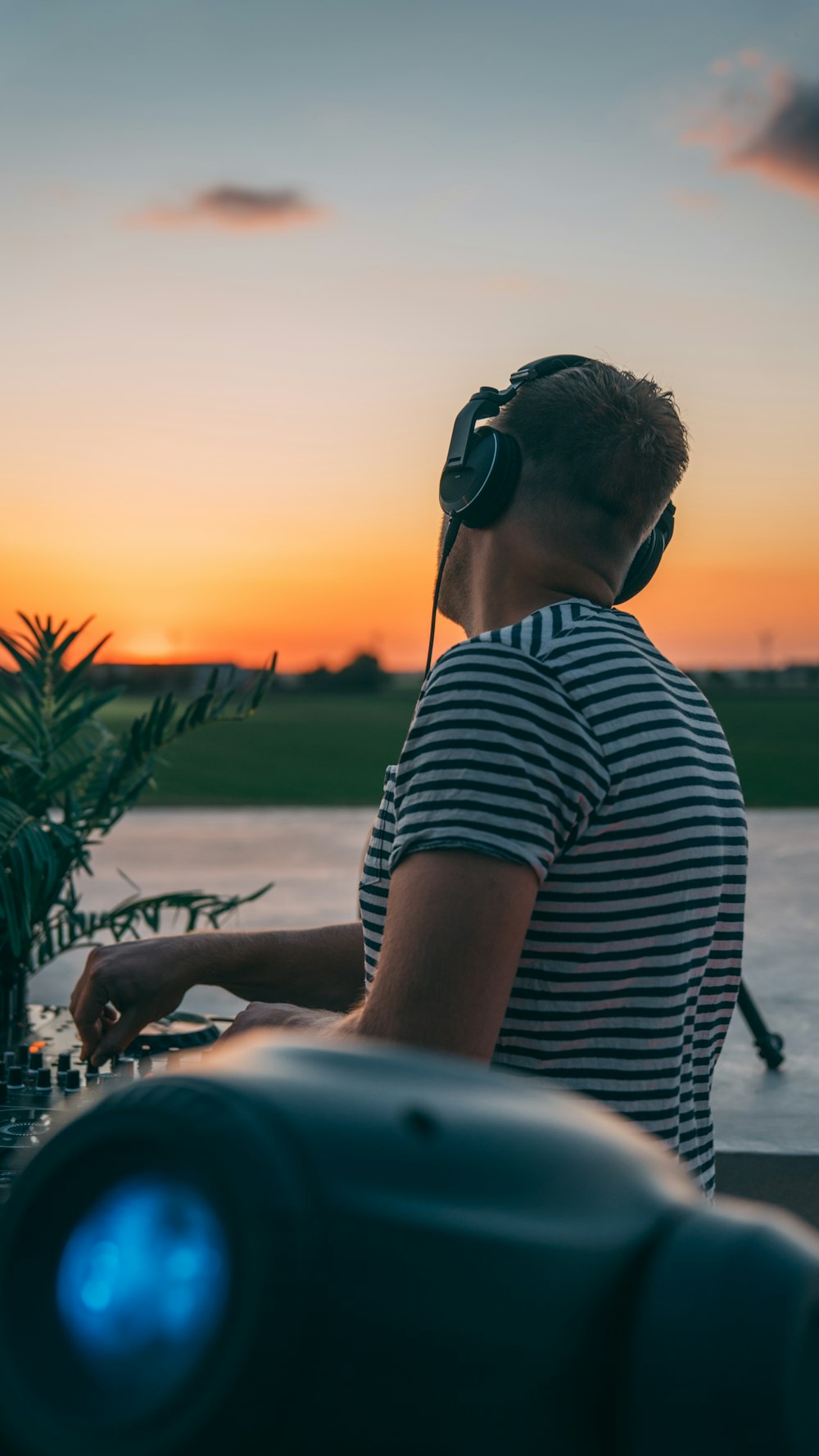 man in black and white striped shirt wearing black sunglasses